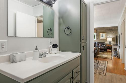 a bathroom with a sink and a mirror at Mountain View Cottage by Carolina Mornings in Waynesville