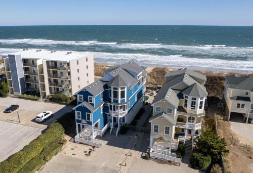 an aerial view of condos and the ocean at Good Karma Retreat - Nags Head MP 15.5, Oceanfront, Elevator, Pool, Hot Tub, Pets OK, Flex Stays in Nags Head