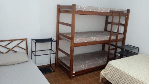 a room with two bunk beds and a bed at Bruno Pereira in Guarujá