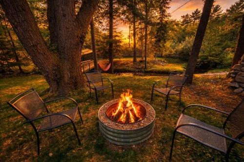 a fire pit in a park with chairs around it at Steps to Beach-Hot Tub-Fireplace-Northern Original in Traverse City