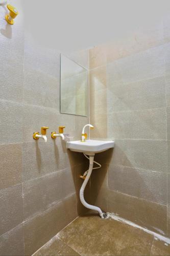 a bathroom with a sink and a mirror at The Prem Royal Resort & Hotel in Dāūd Khān