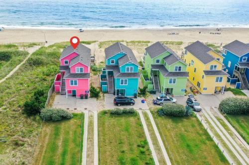 an aerial view of a row of houses on the beach at Carolina Sunshine - Nags Head MP 16, Oceanfront, Pool, Hot Tub, Pets OK, Flex Stays in Nags Head