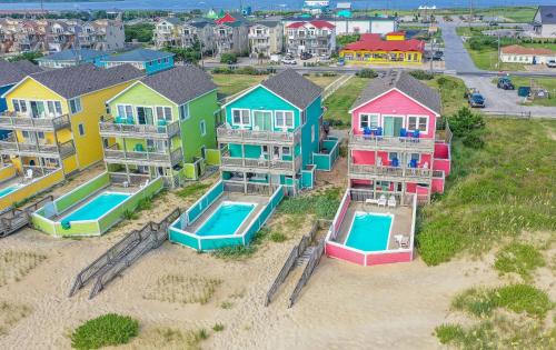 an aerial view of a row of houses with a pool at Carolina Sunshine - Nags Head MP 16, Oceanfront, Pool, Hot Tub, Pets OK, Flex Stays in Nags Head