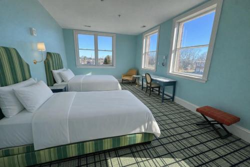 a hotel room with two beds and two windows at The Laurel Hotel in Danville