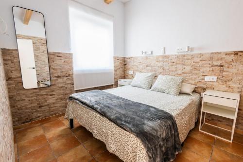 a bedroom with a large bed and a mirror at GuestReady - Calvario Rota 30 JC in Rota