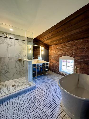 a bathroom with a bath tub and a sink at The Laurel Hotel in Danville