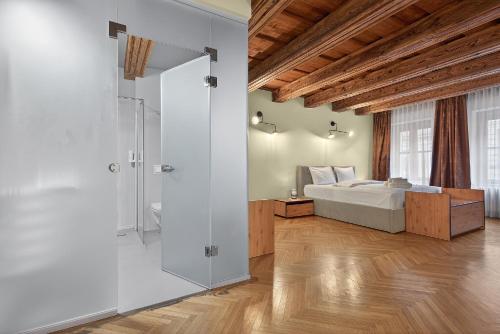 a bedroom with a bed and a glass shower at Schloss Haus Boutique in Braşov