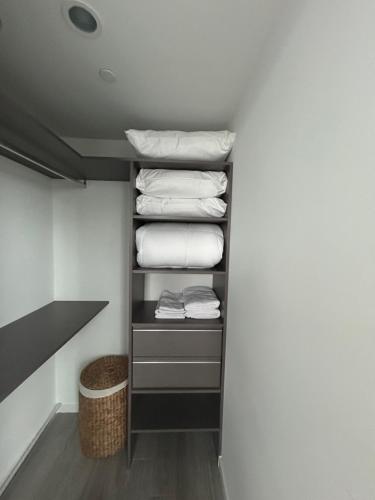 a laundry room with folded towels on a shelf at Miami-Brickell Luxury 2BR-2BATH with skyline VIEWS - walking distance to KASEYA-HEAT ARENA & BAYSIDE - Port of MIAMI cruise ships in Miami