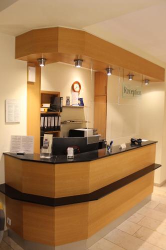 a reception area of a hospital with a counter at Hotel Bitburger Hof in Bitburg