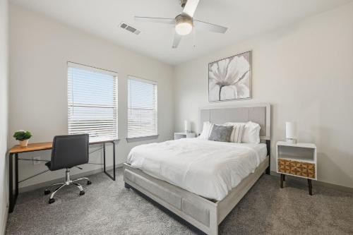 a bedroom with a bed and a desk and a computer at Chisholm Trace 812 Perfect 2BD 2BA in Cleburne