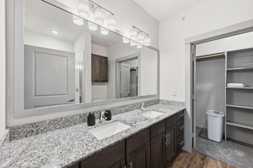 a bathroom with two sinks and a large mirror at Chisholm Trace 812 Perfect 2BD 2BA in Cleburne