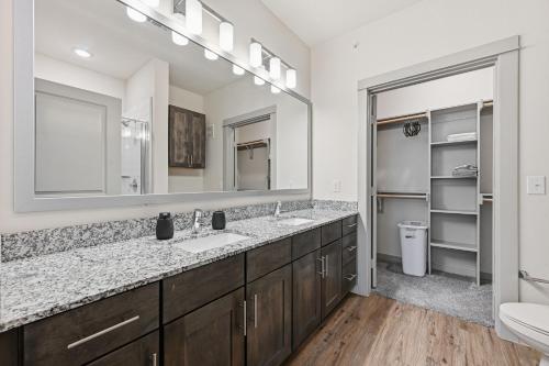 a bathroom with two sinks and a large mirror at Chisholm Trace 327 Relaxing 2BD 2BA in Cleburne
