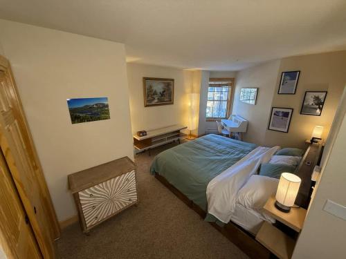 a bedroom with a large bed and a desk at Family Ski Getaway in Kirkwood