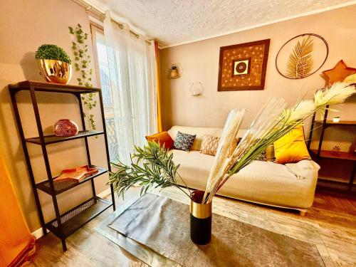 a living room with a couch and a table at Le Jacuzzi Room in Perpignan