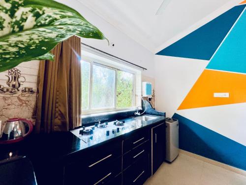 a bathroom with a sink and a window at 2BHK Stunning Apartment with Pool in Vagator