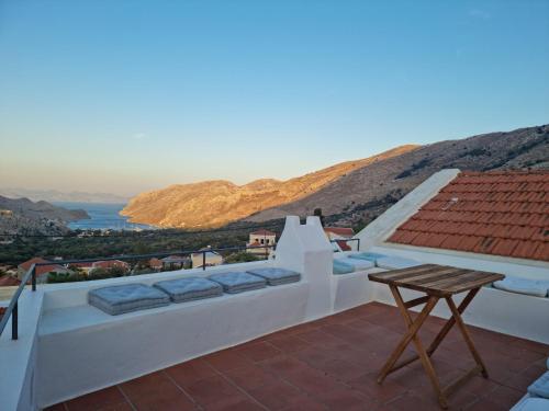 a balcony with a table and a view of the ocean at Symi Village House in Symi