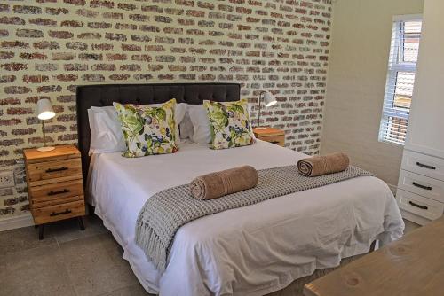 a bedroom with a bed and a brick wall at 1001 Pont de Val in Parys