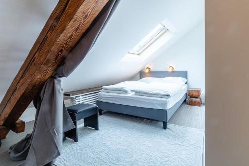 a bedroom with a bed and a stair case at Black Apartment - Large Spacious One Bedroom Penthouse Loft in Baden-Baden