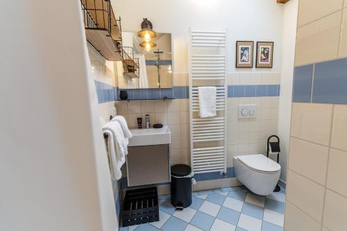 a bathroom with a toilet and a sink at Black Apartment - Large Spacious One Bedroom Penthouse Loft in Baden-Baden