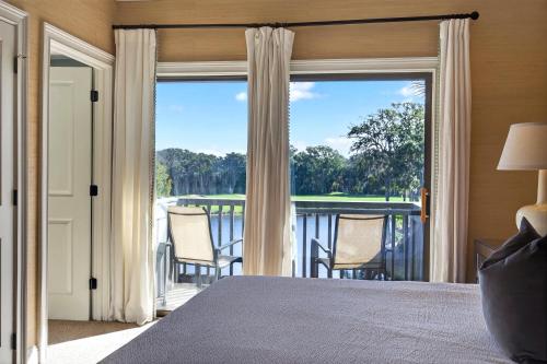 a bedroom with a bed and a balcony with a view at 4922 Turtle Point in Kiawah Island
