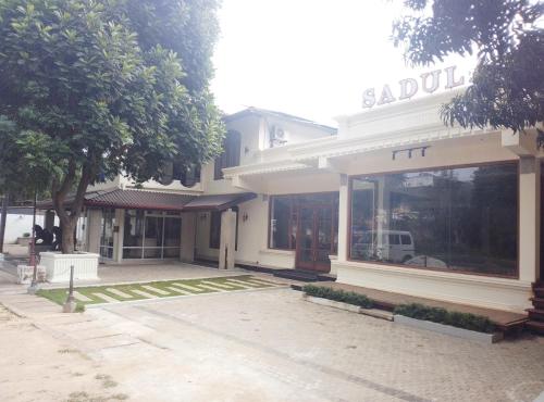 a building with a sign on the front of it at Sadula Holiday Resort in Anuradhapura