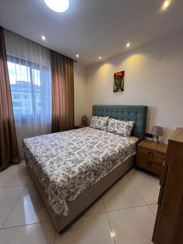 a bedroom with a large bed and a window at Serenity Residence lux1plus1 in Alanya