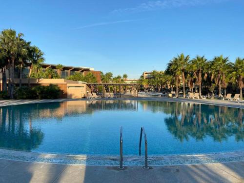 a large swimming pool with palm trees in the background at Salgados Retreat in Bicas