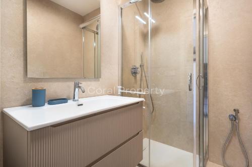 a bathroom with a sink and a shower at Suite Rea Beachfront - Giardino & Spiaggia Privata - by Coral Property in Porto Cervo