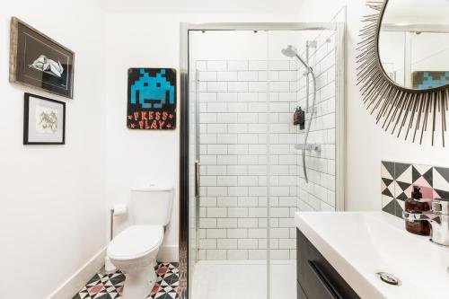 a white bathroom with a toilet and a shower at 2 Boutique apartments up to 3 parking spaces in Gloucester