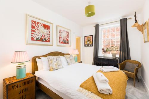 a bedroom with a large bed and a window at 2 Boutique apartments up to 3 parking spaces in Gloucester