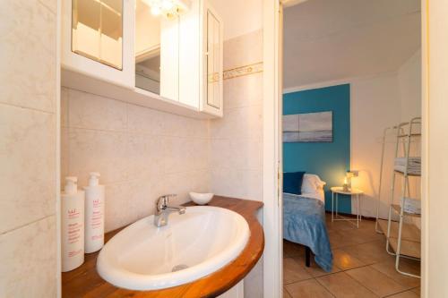 a bathroom with a sink in a room at Azure Comfort Studio in Bellagio