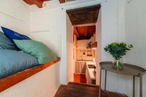 a small room with a bed and a table in it at Beach Lake Apartment in Bellagio
