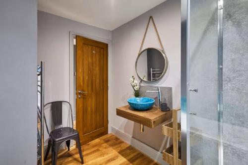 a bathroom with a sink and a mirror at Spacious 2BR with garden in Alnwick
