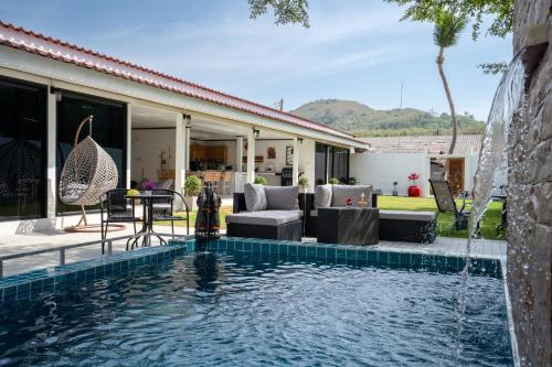 a swimming pool in front of a house at Private Luxury Villa 4BR Pool Near Beach in Ko Lanta