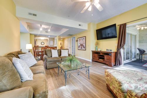 a living room with a couch and a tv at Golf Course Home with Balcony in North Myrtle Beach! in North Myrtle Beach