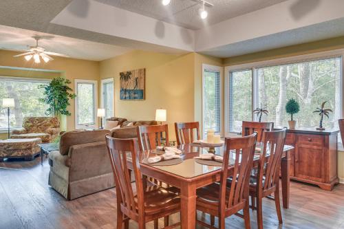 a dining room and living room with a table and chairs at Golf Course Home with Balcony in North Myrtle Beach! in North Myrtle Beach