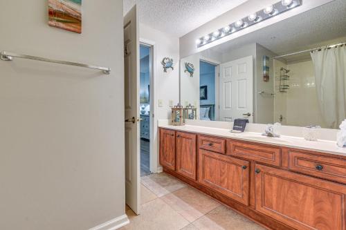 a bathroom with a sink and a large mirror at Golf Course Home with Balcony in North Myrtle Beach! in North Myrtle Beach