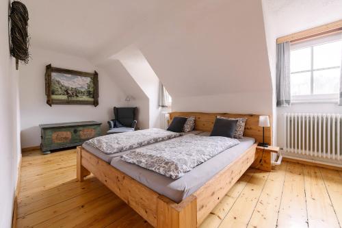 a bedroom with a wooden bed in a attic at Rinntaverne in Palfau
