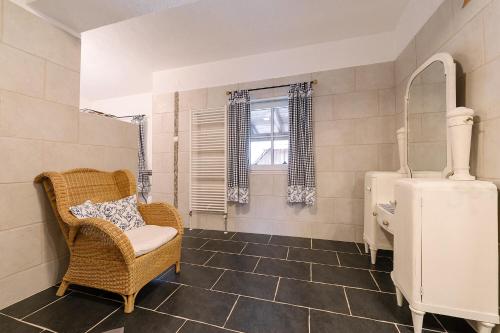 a bathroom with a chair and a sink at Rinntaverne in Palfau