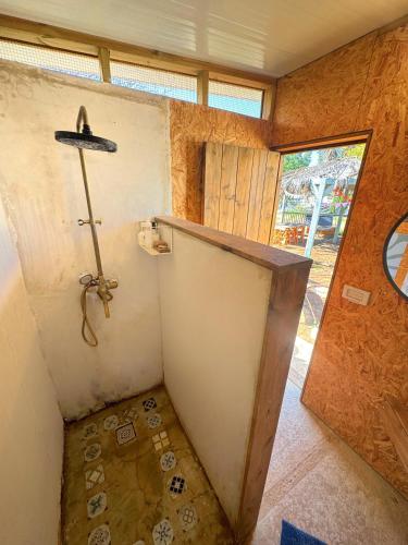 a small bathroom with a shower in a house at משק רפאל - פרדס חנה in Pardes H̱anna