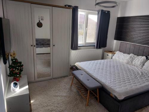 a bedroom with a bed and a christmas tree in it at Casa Capibarei 3 in Bragadiru