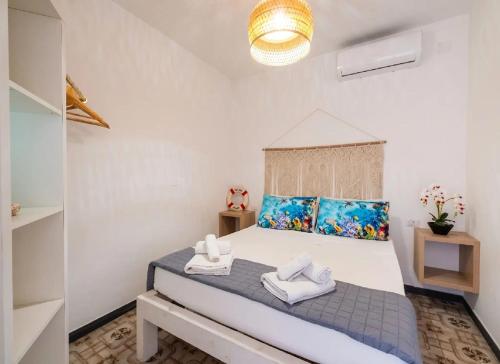 a bedroom with a large bed with towels on it at Fronte Mare in Centro a Torre Lapillo in Torre Lapillo