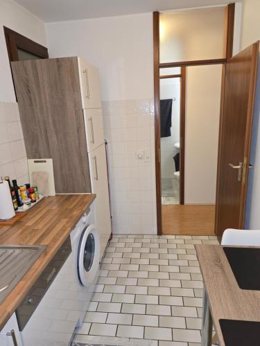 a bathroom with a sink and a washing machine at Studio Apartment in Stuttgart