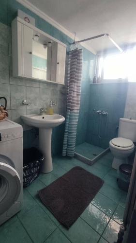a bathroom with a sink and a toilet at Ampolias rooms Messolonghi in Missolonghi