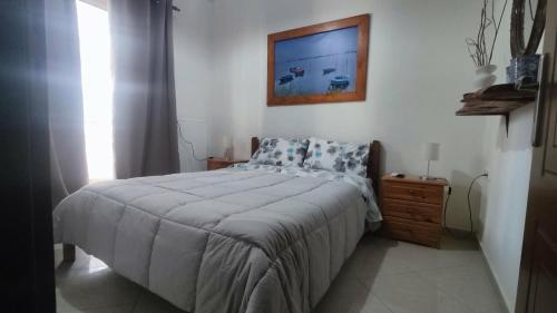 a bedroom with a bed and a tv on the wall at Ampolias rooms Messolonghi in Missolonghi