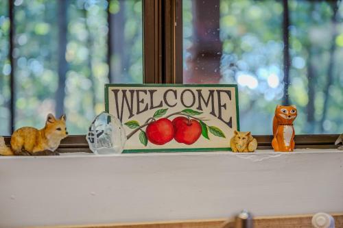 a welcome sign sitting on top of a window sill at Fox Hollow - Hot Tub, Wifi, Pet Friendly, Screen Porch, Deck, Recreation Center, Pool Access, Golf Nearby, Hiking, Grill, Fireplace, King Bed in Hedgesville