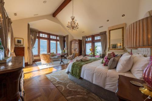 a bedroom with a large bed in a room with windows at Chateau Okanagan in Kelowna