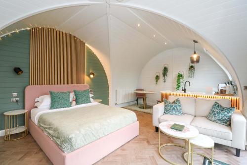 a bedroom with a bed and a couch at Crofters Suite in Acharacle