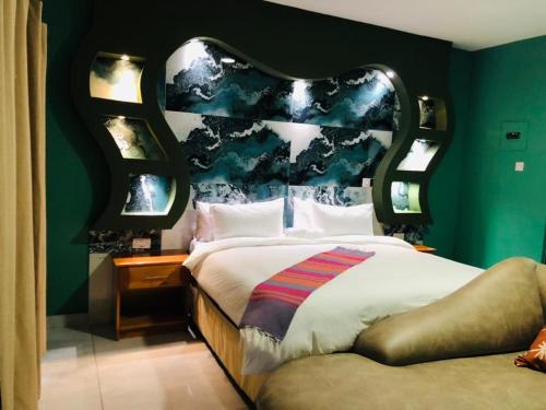 a bedroom with a large bed with a blue wall at Makgadikgadi Riverview Inn in Nata