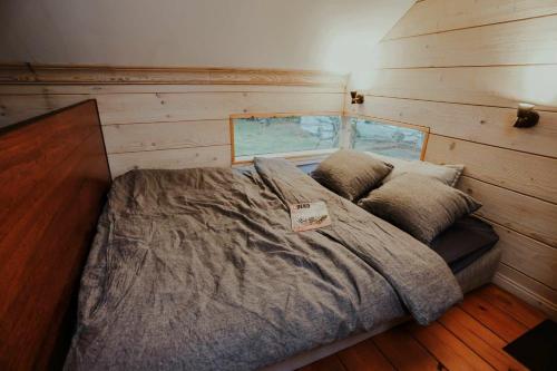 a bedroom with a bed with a sign on it at Brīvdienu Māja Martz in Engure